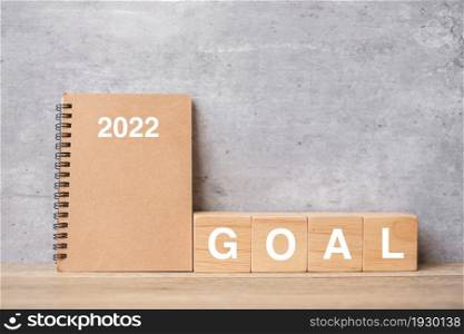 2022 calendar with GOAL block on wood table. Happy New Year, motivation, Resolution, To do list, start, Strategy and Plan concept