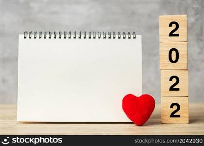 2022 cubes with red heart shape and empty notebook on table for your text. New Year, Resolution, Goal, plan, health, Love and Happy Valentine day concept