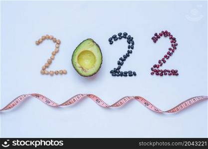 2022 Happy New Year and New You with fruit and vegetable; Avocado, adlay and Bean on table. Goals, Healthy, Motivation, Resolution, Time to New Start, dieting and world food day concept