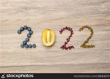 2022 Happy New Year and New You with fruit and vegetable; Blueberries, kiwi and Bean on table. Goals, Healthy, Motivation, Resolution, Time to New Start, dieting and world food day concept