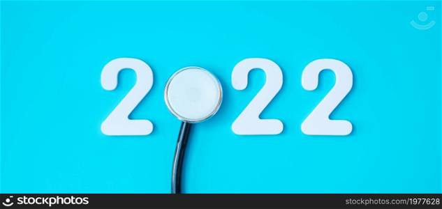 2022 Happy New Year for healthcare, Insurance, Wellness and medical concept. Stethoscope and white number on blue background