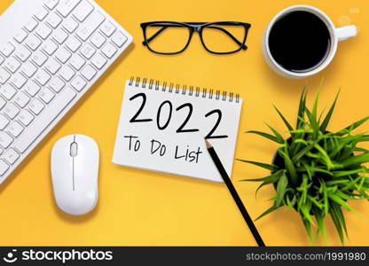 2022 Happy New Year Resolution Goal List and Plans Setting - Business office desk with notebook written about plan listing of new year goals and resolutions setting. Change and determination concept.. 2022 Happy New Year Resolution Goal List and Plans Setting