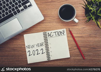 2022 Happy New Year Resolution Goal List and Plans Setting - Business office desk with notebook written about plan listing of new year goals and resolutions setting. Change and determination concept.