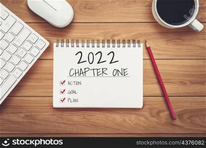 2022 Happy New Year Resolution Goal List and Plans Setting - Business office desk with notebook written about plan listing of new year goals and resolutions setting. Change and determination concept.