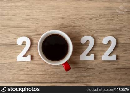 2022 Happy New Year with coffee cup and Christmas decoration on wood table background. New Start, Resolution, countdown, Goals, Plan, Action and Mission Concept