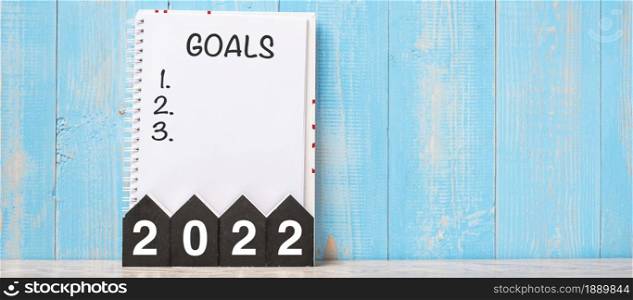 2022 Happy New Year with GOAL word and wooden number. time for a New Start, Resolution, Plan, Action and Mission Concept