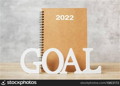 2022 Happy New Year with notebook and wooden number. goal, countdown, Resolution, Plan, Action and Mission Concept