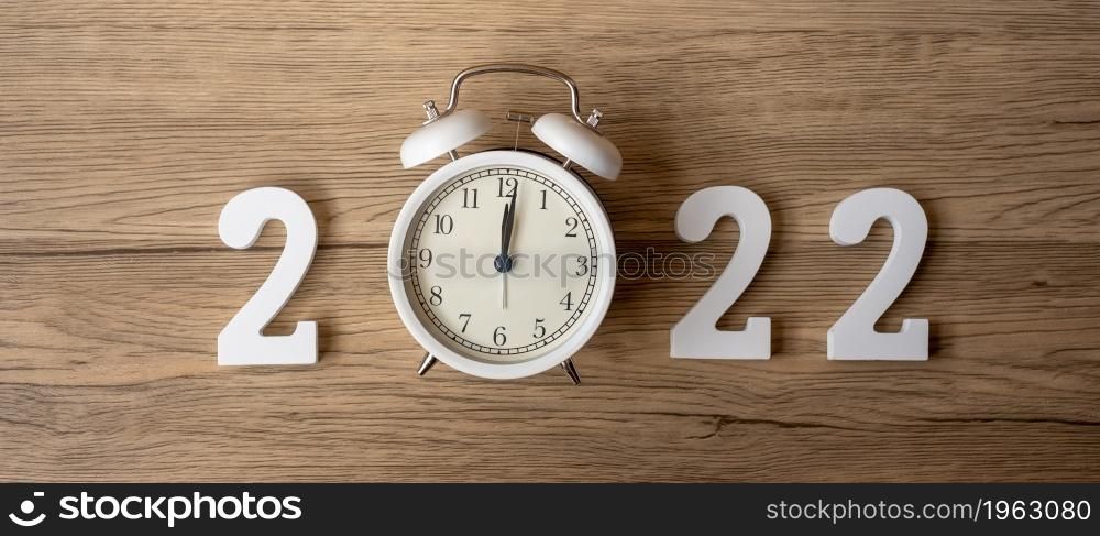 2022 Happy New Year with retro alarm clock and wooden number. Merry Christmas, New Start, Resolution, countdown, Goals, Plan, Action and Mission Concept