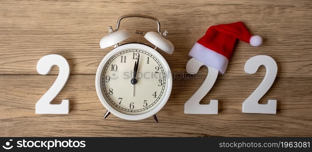 2022 Happy New Year with retro alarm clock and wooden number. Merry Christmas, New Start, Resolution, countdown, Goals, Plan, Action and Mission Concept