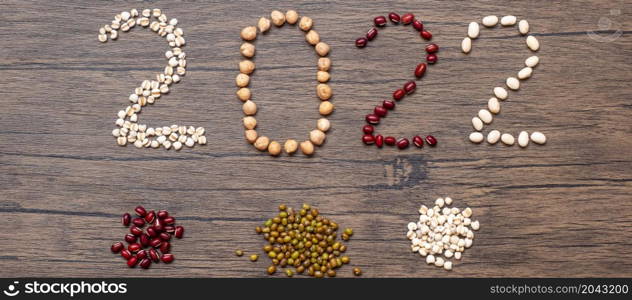 2022 New Year and New You with organic Beans; red, black, white, green, chickpeas and Adlay on table. Goals, Healthy, Motivation, Resolution, Weight loss, dieting and world food day concept