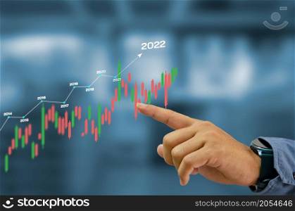 2022 New year candlestick graph chart auto trade, business finance investment stock exchange market concept background.