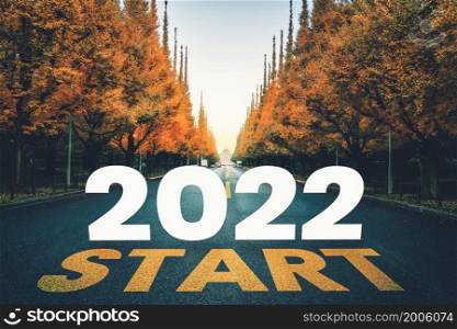 2022 New Year road trip travel and future vision concept . Nature landscape with highway road leading forward to happy new year celebration in the beginning of 2022 for fresh and successful start .. 2022 New Year road trip travel and future vision concept