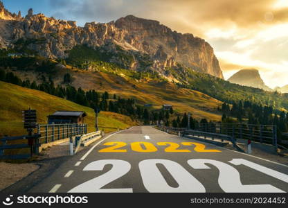 2022 New Year road trip travel and future vision concept . Nature landscape with highway road leading forward to happy new year celebration in the beginning of 2022 for fresh and successful start .. 2022 New Year road trip travel and future vision concept