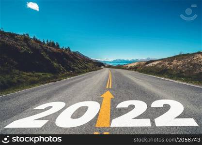 2022 New Year road trip travel and future vision concept . Nature landscape with highway road leading forward to happy new year celebration in the beginning of 2022 for fresh and successful start .
