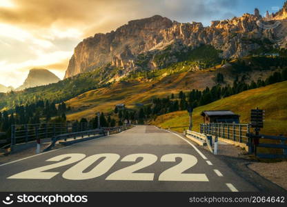 2022 New Year road trip travel and future vision concept . Nature landscape with highway road leading forward to happy new year celebration in the beginning of 2022 for fresh and successful start .