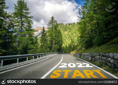 2022 New Year road trip travel and future vision concept . Nature landscape with highway road leading forward to happy new year celebration in the beginning of 2022 for fresh and successful start .