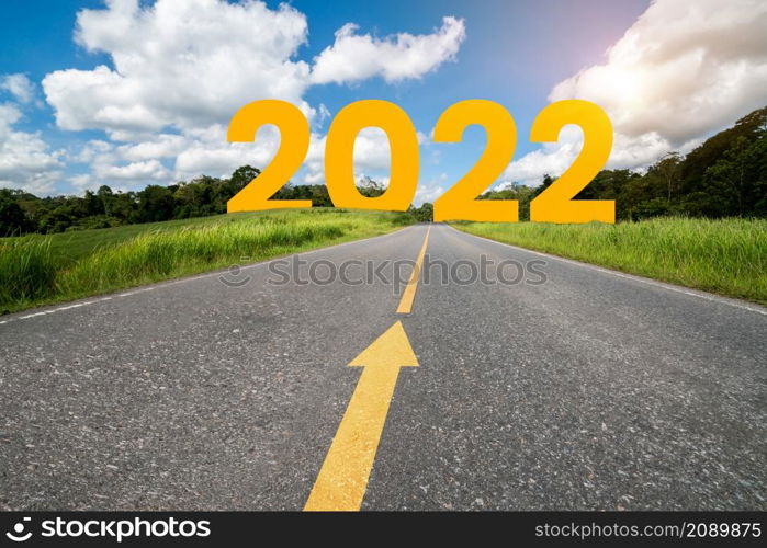 2022 New Year road trip travel and future vision concept . Nature landscape with highway road leading forward to happy new year celebration in the beginning of 2022 for fresh and successful start .