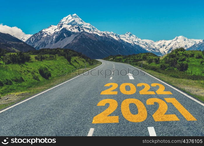 2022 New Year road trip travel and future vision concept . Nature landscape with highway road leading forward to happy new year celebration in the beginning of 2022 for fresh and successful start .