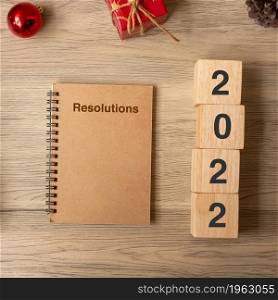 2022 New Year with notebook, Christmas gift and pen on wood table. Xmas, Happy New Year, Goals, Resolution, To do list, start, Strategy and Plan concept