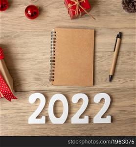 2022 New Year with notebook, Christmas gift and pen on wood table. Xmas, Happy New Year, Goals, Resolution, To do list, start, Strategy and Plan concept