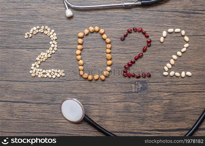 2022 New Year with organic Beans; red, white, chickpeas and Adlay on table. Goals, Healthy, Motivation, Resolution, Weight loss, dieting and world food day concept