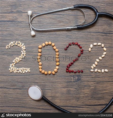 2022 New Year with organic Beans; red, white, chickpeas and Adlay on table. Goals, Healthy, Motivation, Resolution, Weight loss, dieting and world food day concept