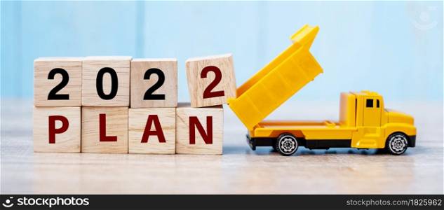 2022 Plan cube blocks with miniature truck or construction vehicle. New Start, Vision, Resolution, goal, industrial, Warehouse and happy New Year concept