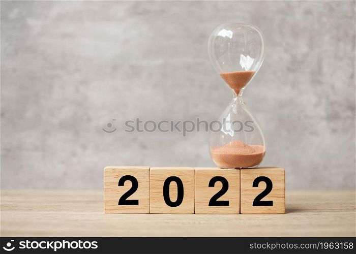 2022 text with hourglass on table. Resolution, time, plan, goal, motivation, reboot, countdown and New Year holiday concepts
