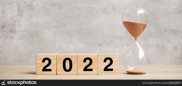 2022 text with hourglass on table. Resolution, time, plan, goal, motivation, reboot, countdown and New Year holiday concepts