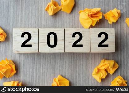 2022 text wood cube and crumbled paper on wooden table background. New Year New Ideas, Creative, Innovation, Imagination, inspiration, Resolution, Strategy and goal concept