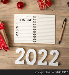 2022 to do list With notebook, Christmas gift and pen on wood table. Xmas, Happy New Year, Goals, Resolution, start, Strategy and Plan concept