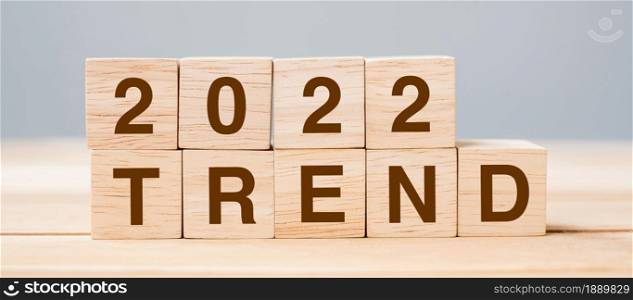 2022 TREND cube block on table background. Resolution, plan, review, change, start and New Year holiday concepts