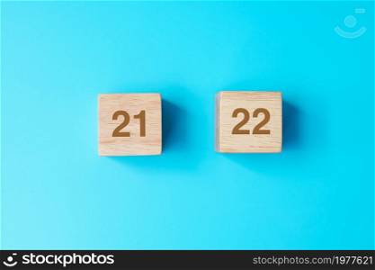 2022 wooden cube blocks on blue background. Resolution, plan, review, goal, start and New Year holiday concepts