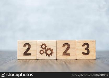 2023 block with gear icon. Business Process, Team, teamwork, Goal, Target, Resolution, strategy, plan, Action, motivation, change, brainstorm and New Year start concepts