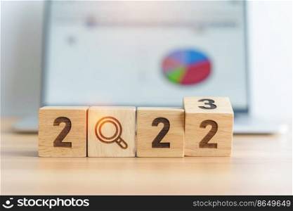 2023 block with magnifying glass icon against laptop background. Hiring, recruitment, job, jobless SEO, Search Engine Optimization and New Year concepts
