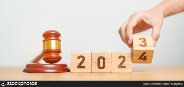 2023 chcnge to 2024 year block with judge gavel on table. Law, lawyer, judgment, justice auction and bidding concept