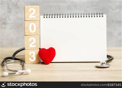 2023 Happy New Year for healthcare, Insurance, Wellness and medical concept. Stethoscope and blank notebook for copy space your text