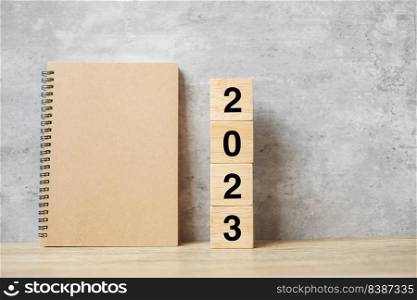 2023 Happy New Year with blank notebook and wooden number. countdown, Resolution, Goals, Plan, Action and Mission Concept