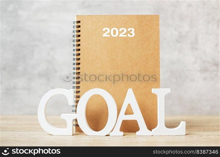 2023 Happy New Year with notebook and wooden number. goal, countdown, Resolution, Plan, Action and Mission Concept