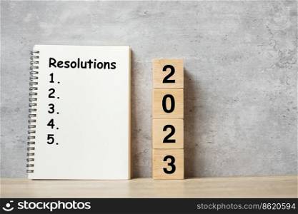 2023 Happy New Year with Resolution notebook and wooden number. countdown, Goals, Plan, Action and Mission Concept
