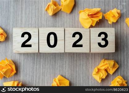 2023 text wood cube and crumbled paper  on wooden table background. New Year New Ideas, Creative, Innovation, Imagination, inspiration, Resolution, Strategy and goal concept