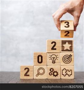 2023 wood block with business success, goal, strategy, target, mission, action, objective, teamwork, plan, idea and New Year start concept