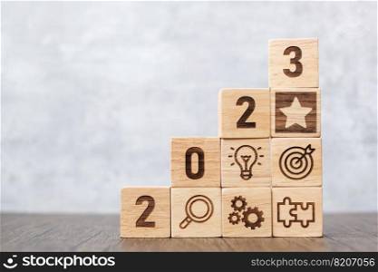 2023 wood block with business success, goal, strategy, target, mission, action, objective, teamwork, plan, idea and New Year start concept