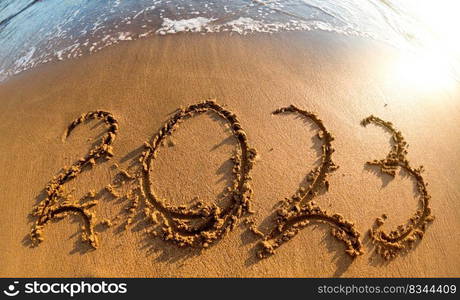 2023 written in sand New Year on the beach