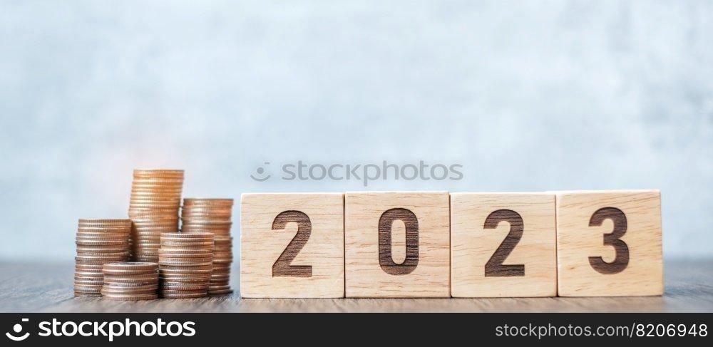 2023 year block with Coins stack. Money, Budget, tax, investment, financial, savings and New Year Resolution concepts