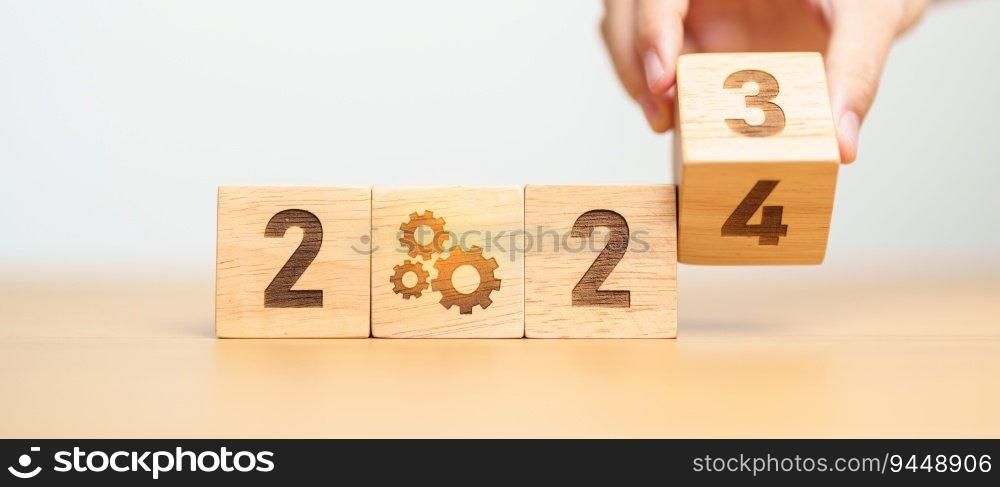 2024 block with gear icon. Business Process, Team, teamwork, Goal, Target, Resolution, strategy, plan, Action, motivation, change, brainstorm and New Year start concepts