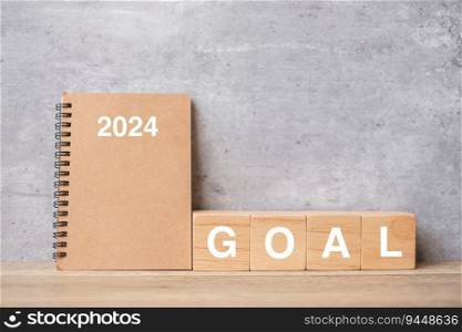 2024 calendar with GOAL block on wood table. Happy New Year, motivation, Resolution, To do list, start, Strategy and Plan concept