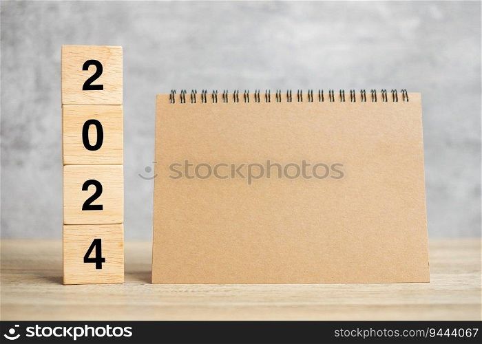 2024 Happy New Year with blank notebook and wooden number. countdown, Resolution, Goals, Plan, Action and Mission Concept