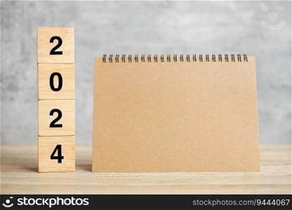 2024 Happy New Year with blank notebook and wooden number. countdown, Resolution, Goals, Plan, Action and Mission Concept