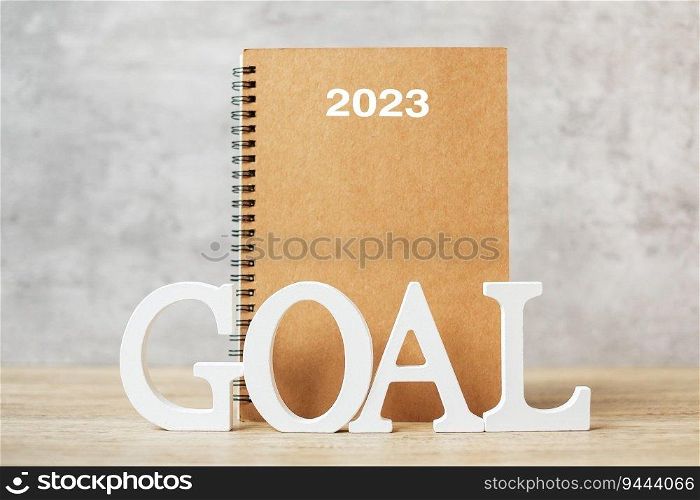 2024 Happy New Year with notebook and wooden number. goal, countdown, Resolution, Plan, Action and Mission Concept